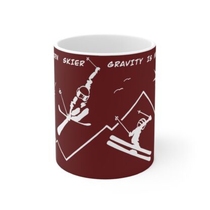 red ceramic cup with a natural born skiers jumping