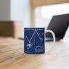 blue ceramic mug with happy skiers on an office desk