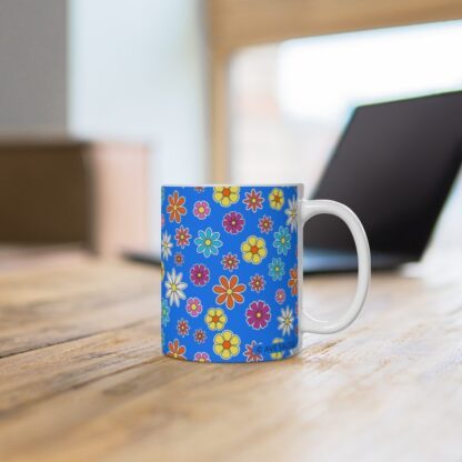 Blue Eyed Mary a sky blue porcelain cup with floral print on desk.