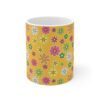 Daffodil a yellow-orange porcelain cup with floral print, front view.