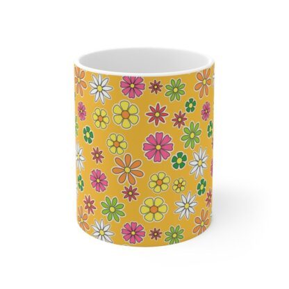 Daffodil a yellow-orange porcelain cup with floral print, front view.