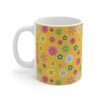 Daffodil a yellow-orange porcelain cup with floral print, handle left.