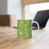 Daisy limegreen porcelain cup with floral print on desk.