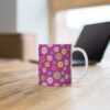 Fuchsia a raspberry redporcelain cup on desk.