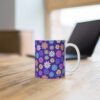 Geranium a purple porcelainup with floral print on desk.