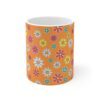 Marigold a orange porcelain cup with floral print, front view.