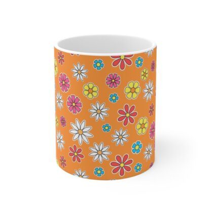 Marigold a orange porcelain cup with floral print, front view.