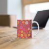 Poppy a red porcelain cup with floral print on desk.