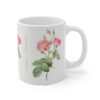 A graceful pink Marie Antoinette Rose on a white porcelain tea mug handle right