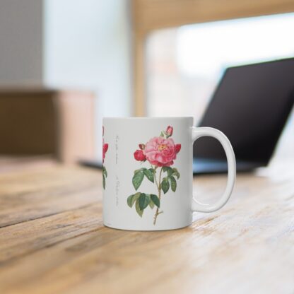 A decorative Rosa Damascena on a white porcelain cup that stands on a desk