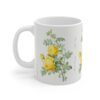 A yellow Rosa Hemisphaerica rose on a white porcelain cup handle left