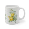 A yellow Rosa Hemisphaerica rose on a white porcelain cup handle right