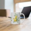 A yellow Rosa Hemisphaerica rose on a white porcelain cup that stands on a desk