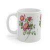 An appealing red Pimpinellifolia rose on a white porcelain cup - handle left