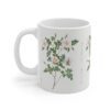 A plain wild Burnet rose on a white porcelain cup - handle left