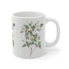 A plain wild Burnet rose on a white porcelain cup - handle right